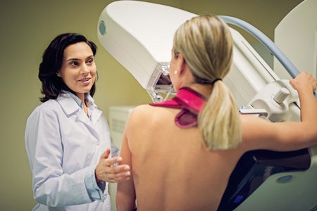 Doctor working with mammography X-ray scanner in hospital