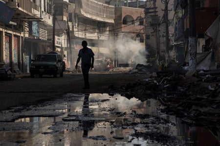 Photo shows the silhouette of a man walking in the middle of a street in Acapulco, Mexico amongst widespread destruction of the landscape, buildings and infrastructure