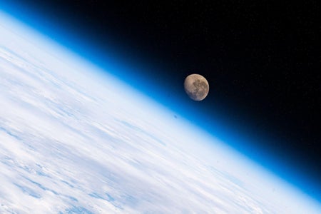 The waning gibbous Moon is pictured above the Earth's horizon