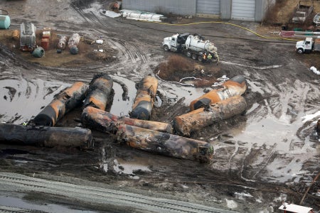 Derailed train cars surrounded by toxic chemical sludge